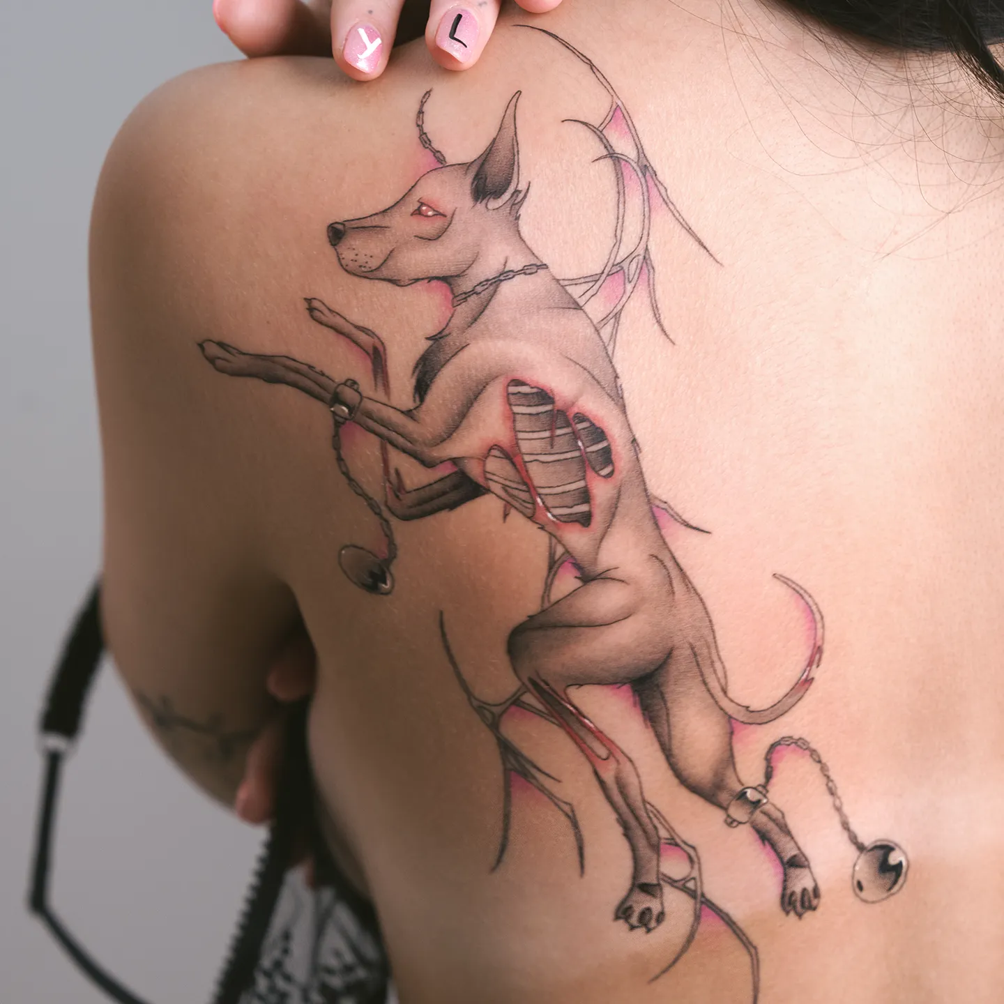 Feminine decorative shoulder tattoo of a wolf