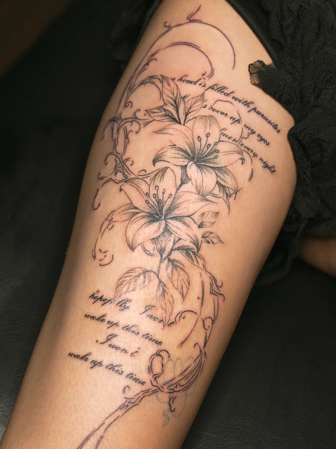 Tattoo of flowers and lettering