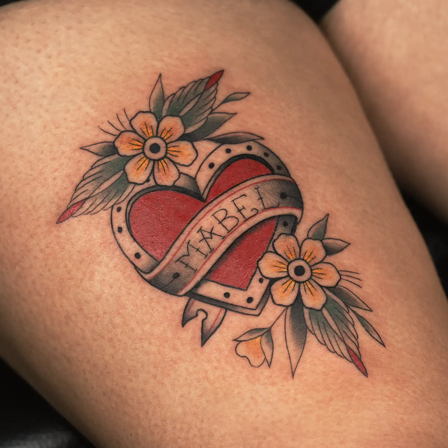 Old-school name and heart tattoo