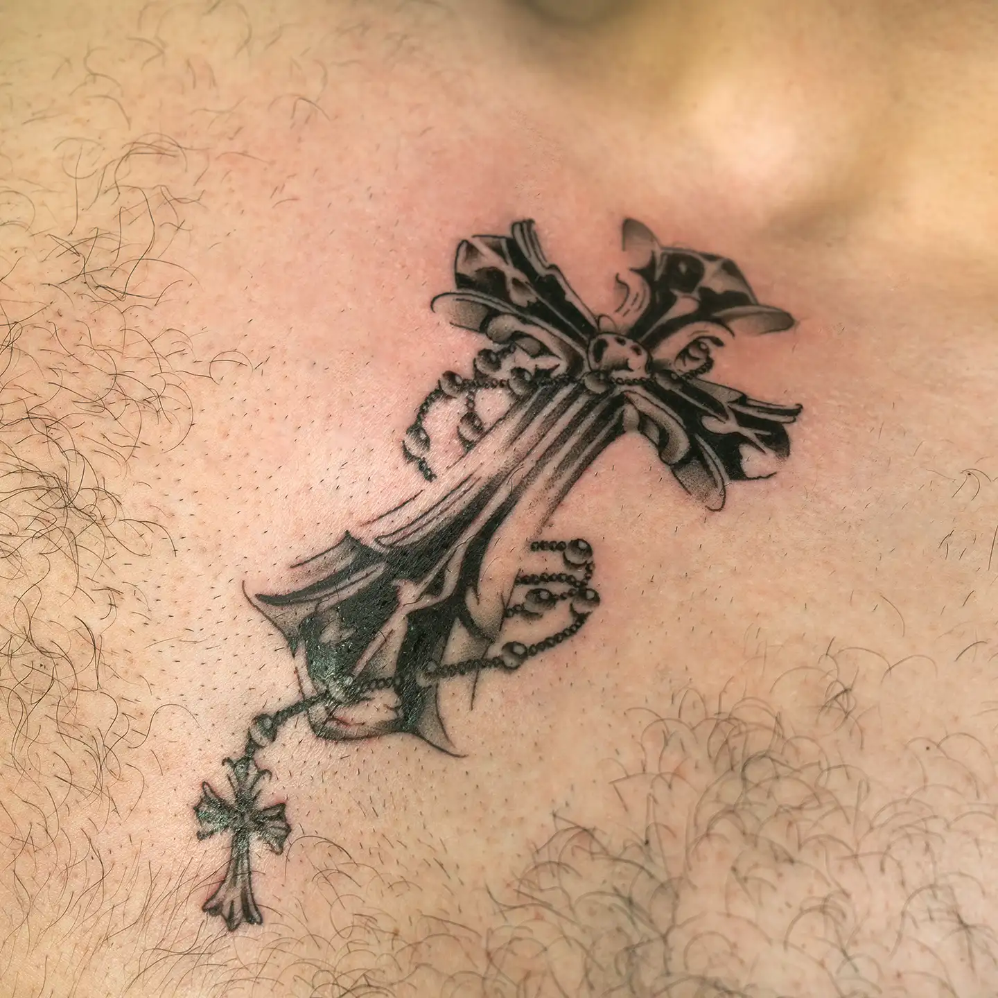 Metallic cross tattoo