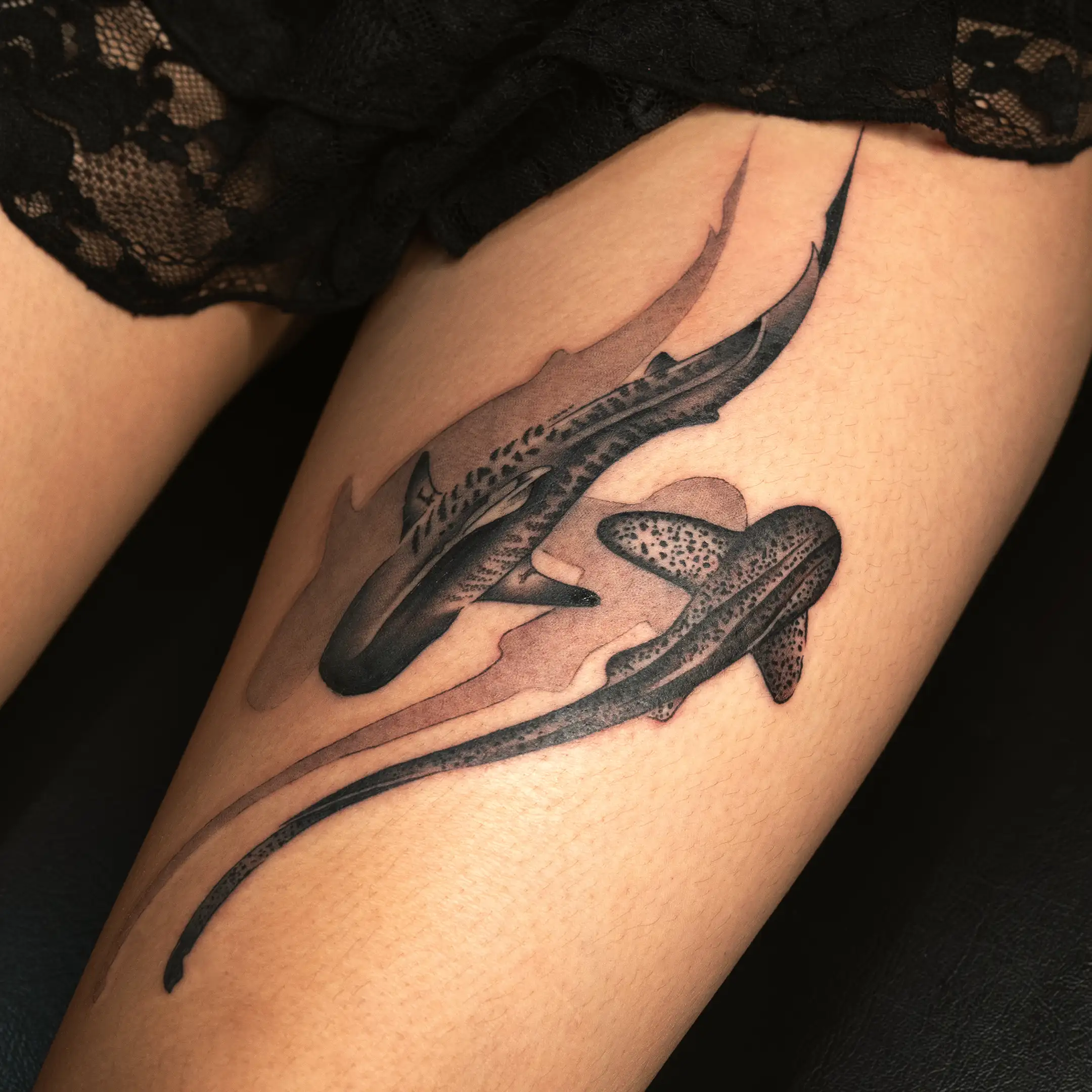 Micro shark tattoos with thigh placement