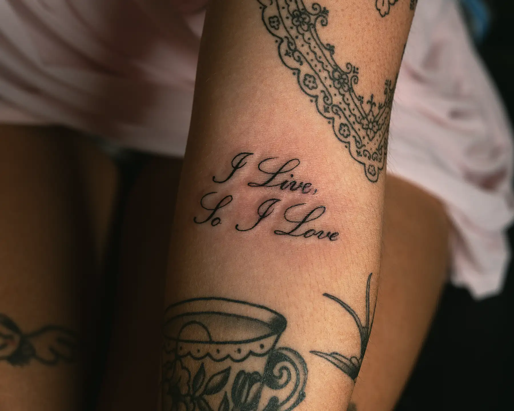 Gothic style womens script tattoo