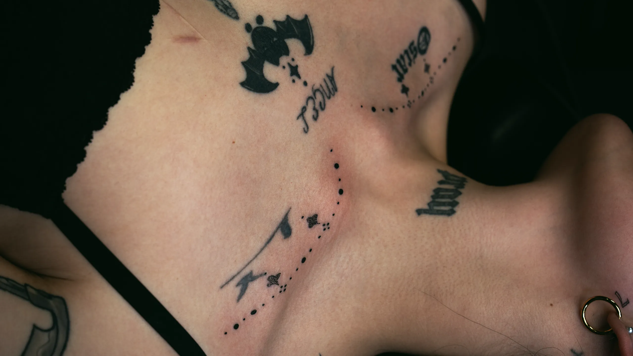 Ornamental flash tattoo on the collar bone