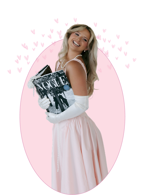 Smiling woman in pink dress and gloves holding Vogue magazines with pink hearts around.