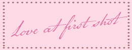 A cursive text saying "Love at first shot" in a pink dotted frame.