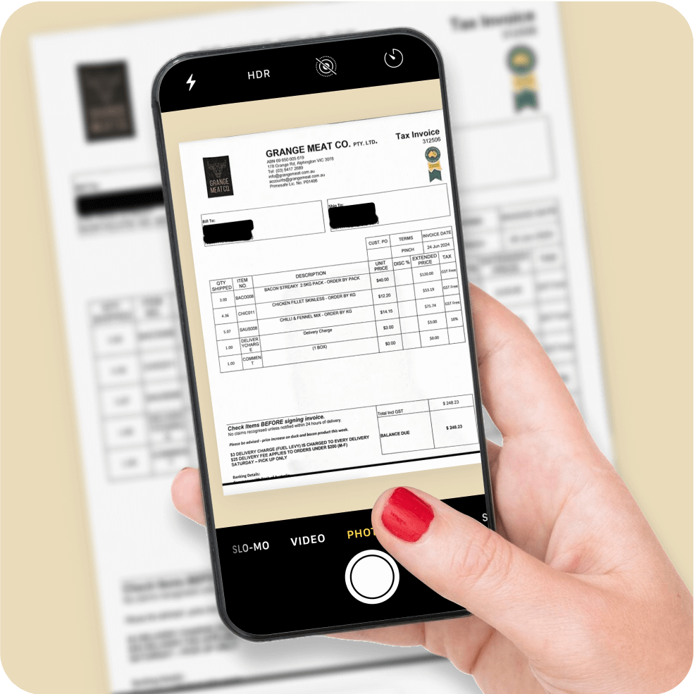Hand with red nail polish holding a smartphone taking a photo of an invoice from Grange Meat Co.