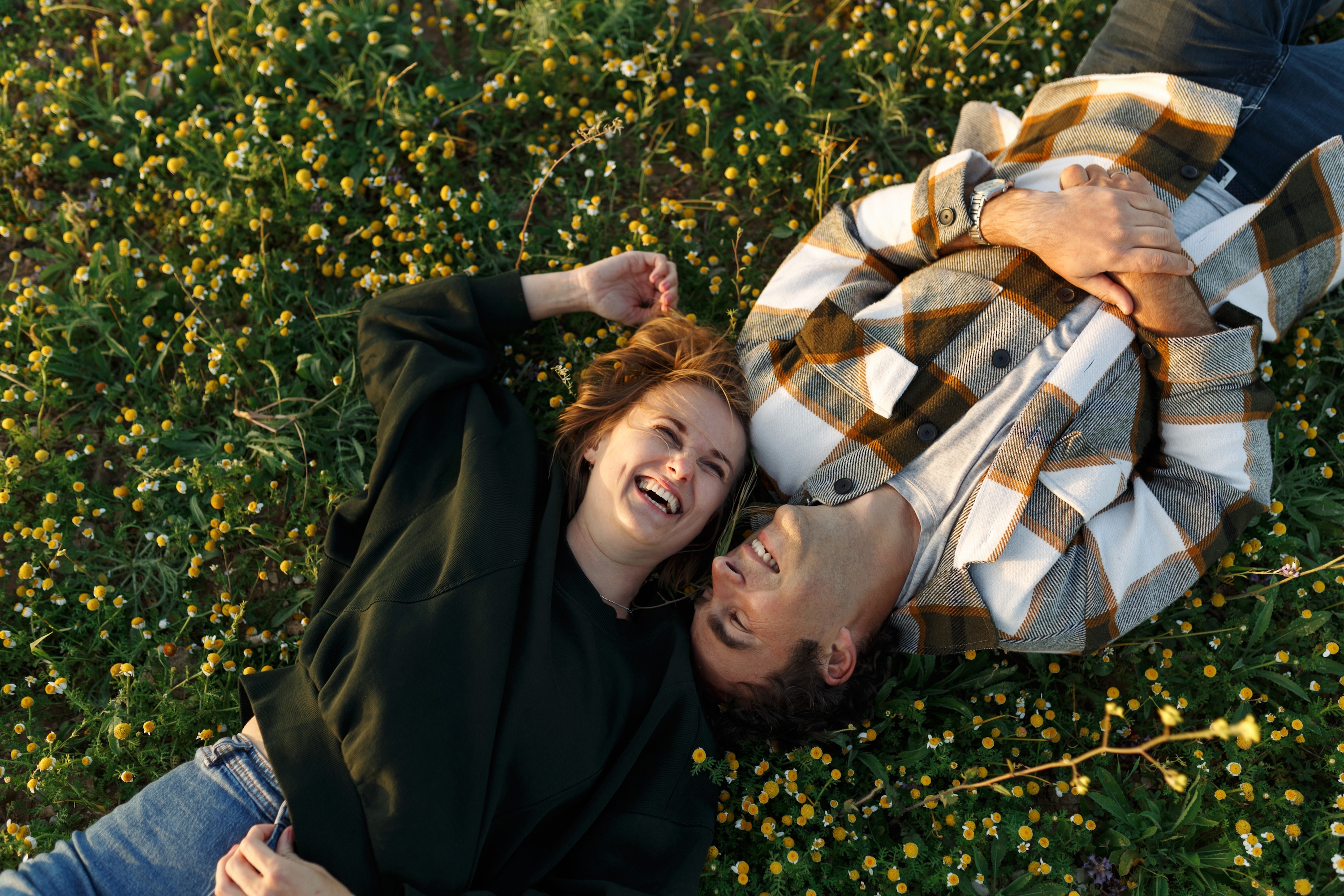 people laying in grass stock image