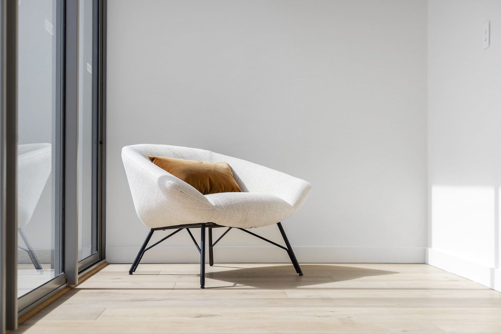 Armchair beside a window in a light-filled Perth home