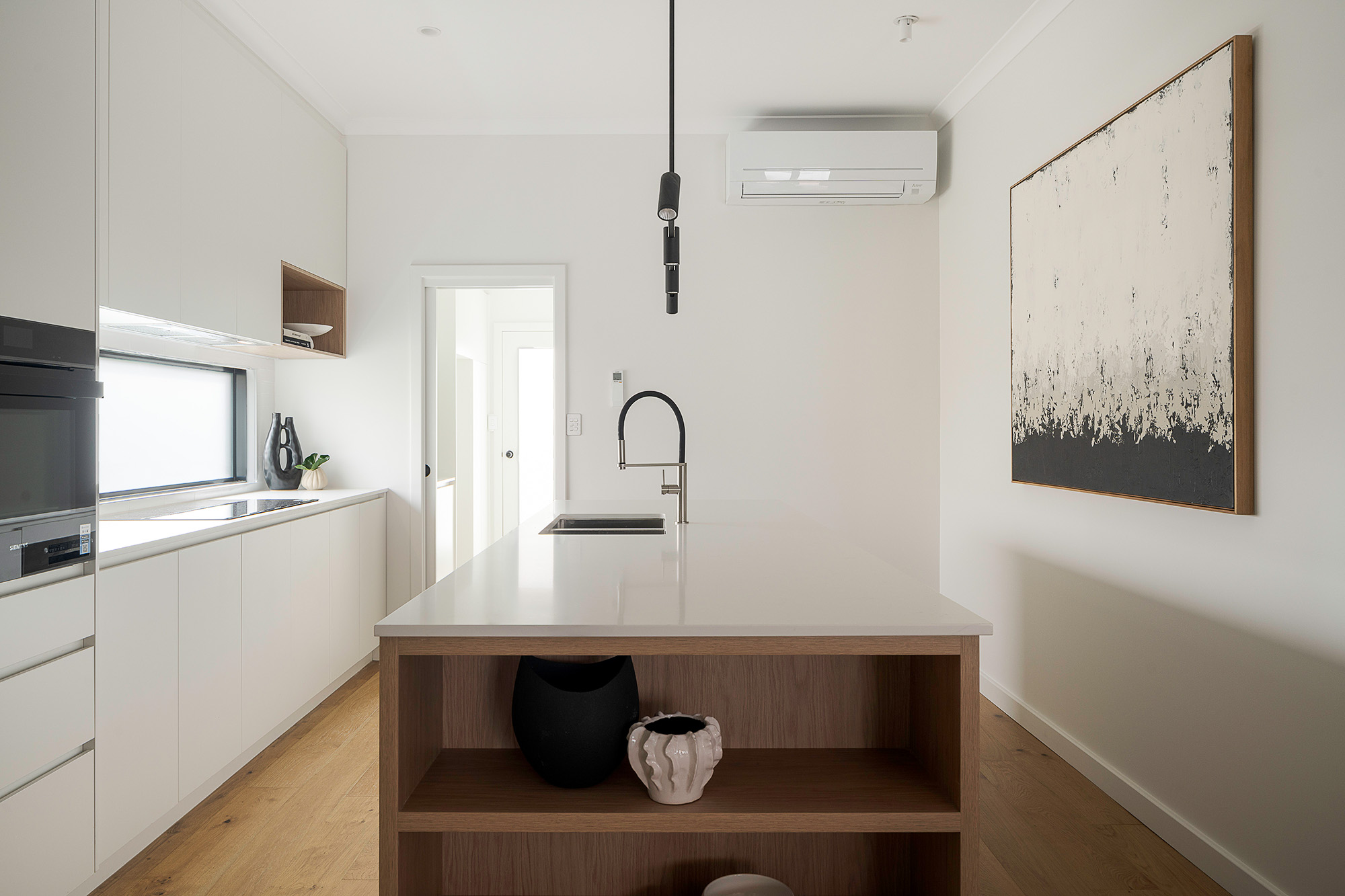Modern kitchen with a timber island bench in a Perth home