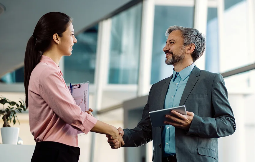 Business consultant shaking hands with a client in a modern office