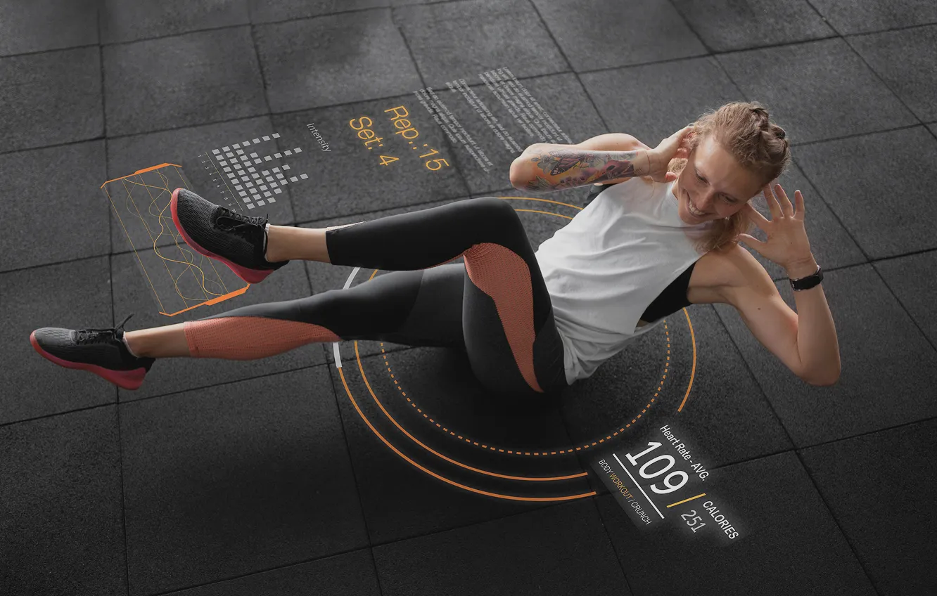 Woman wearing black and orange leggings and a white sleeveless top performing a floor abdominal crunch exercise on a black gym mat, with augmented reality fitness data overlay including reps, sets, heart rate, and calories burned.