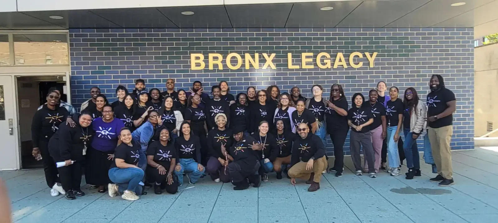 Bronx Legacy High School staff group photo outside school entrance