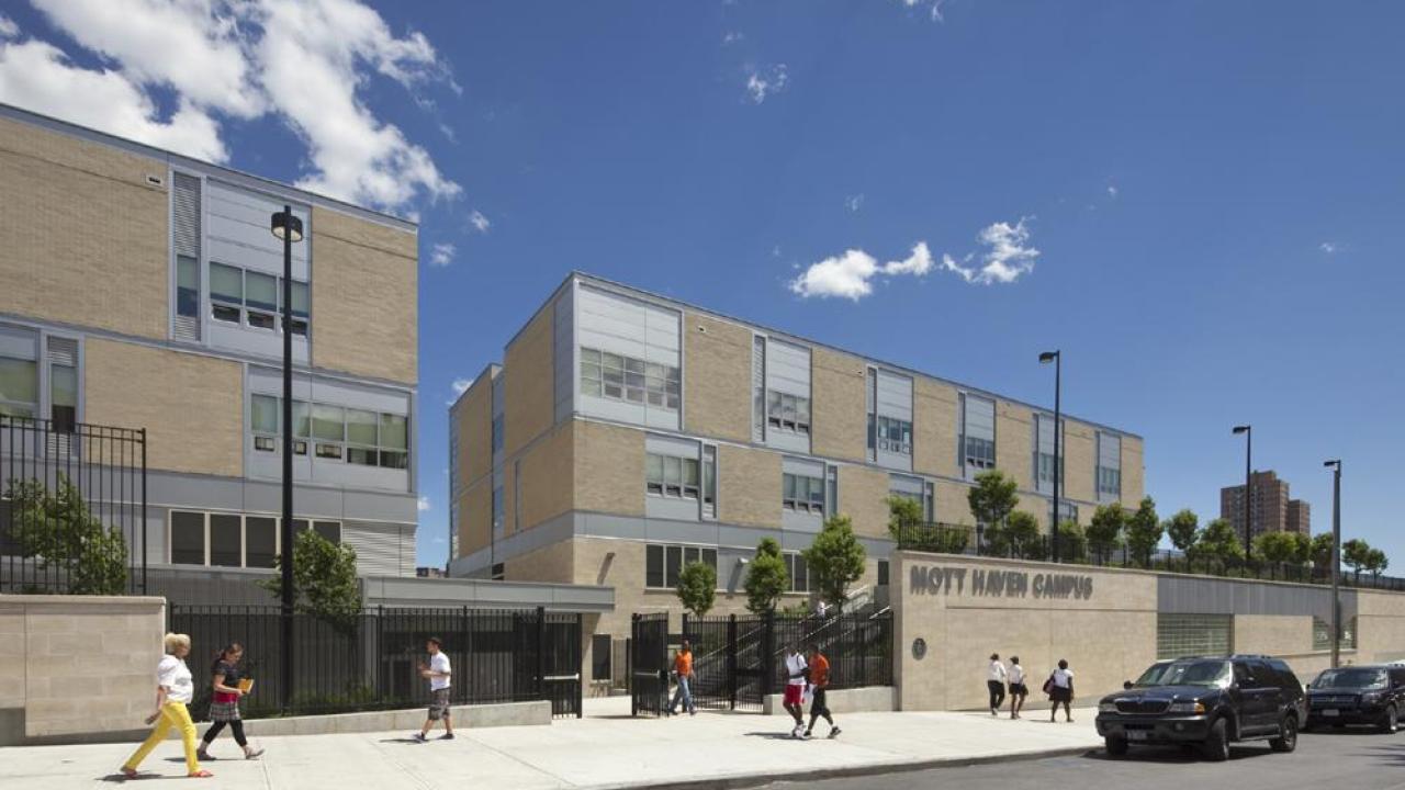 Exterior view of Mott Haven Campus school building with students walking