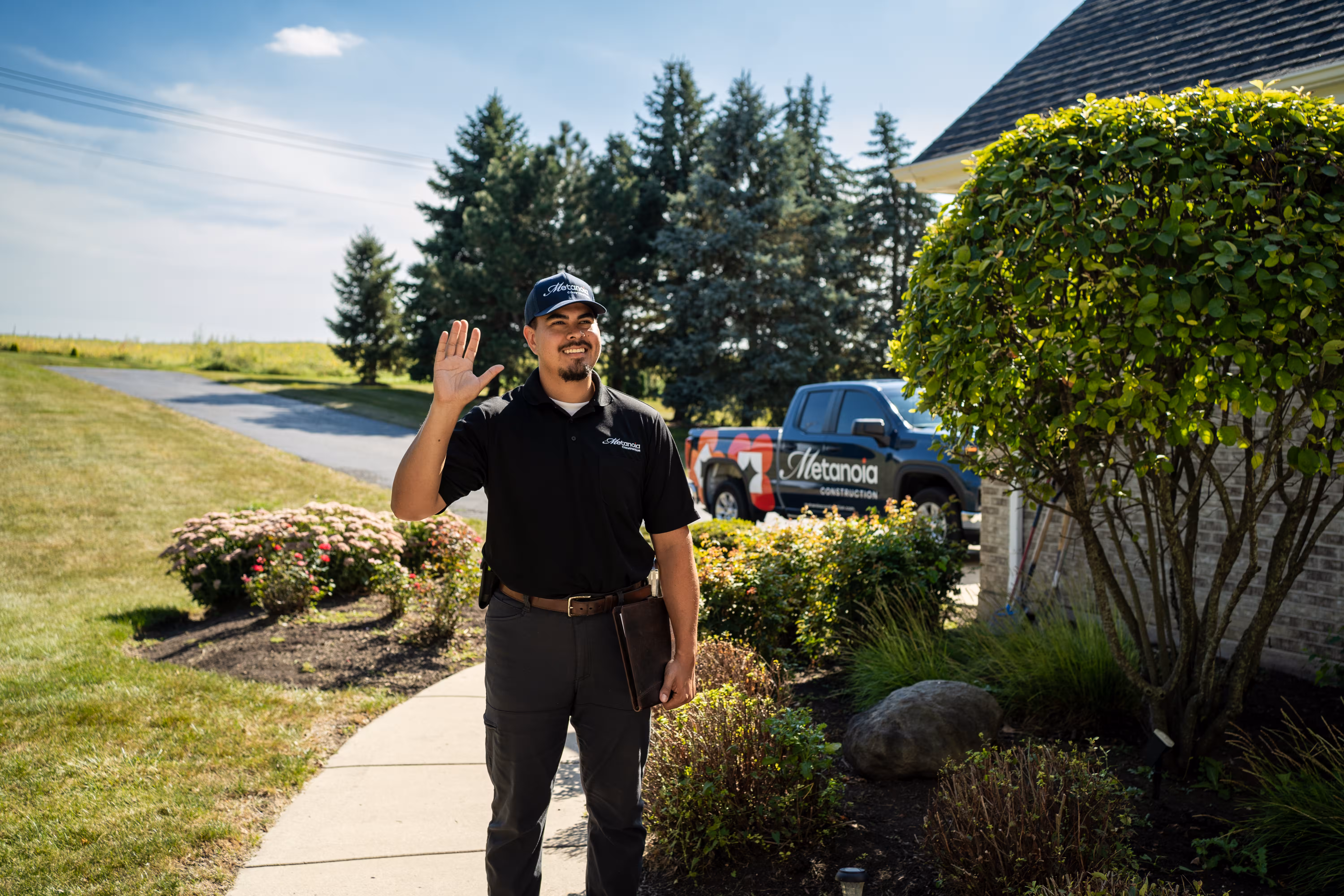 Metanoia Construction estimator greeting a homeowner on the front walk before a walkthrough