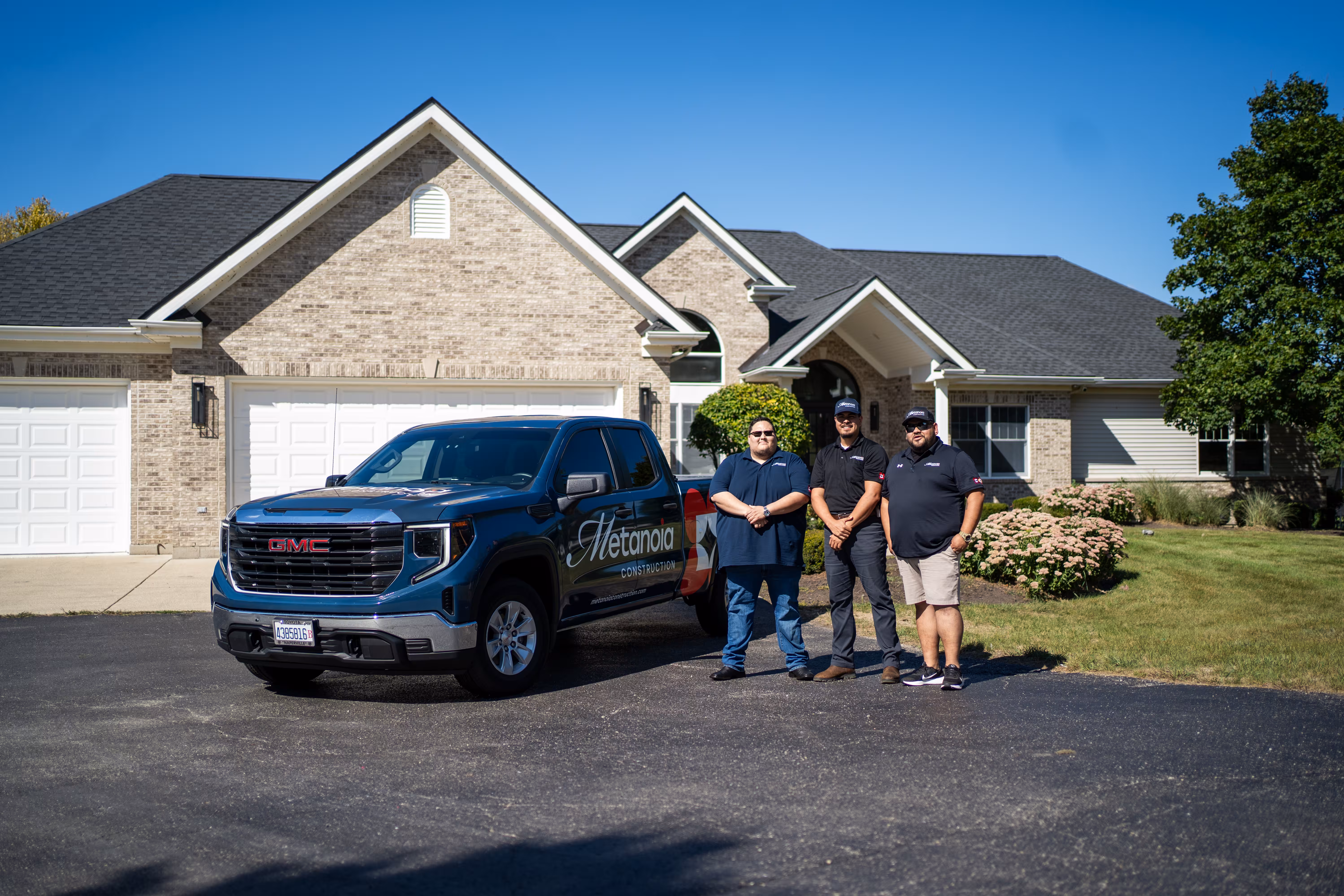 Metanoia Construction crew and branded truck outside a brick ranch home in Batavia, IL
