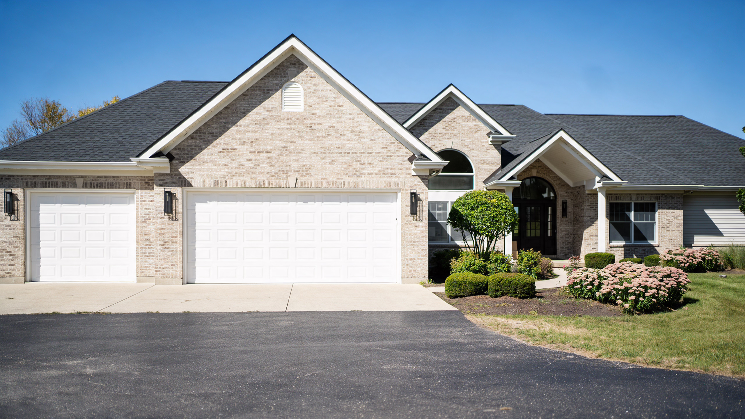 Brick ranch home with a three car garage and landscaped front yard in Batavia, IL