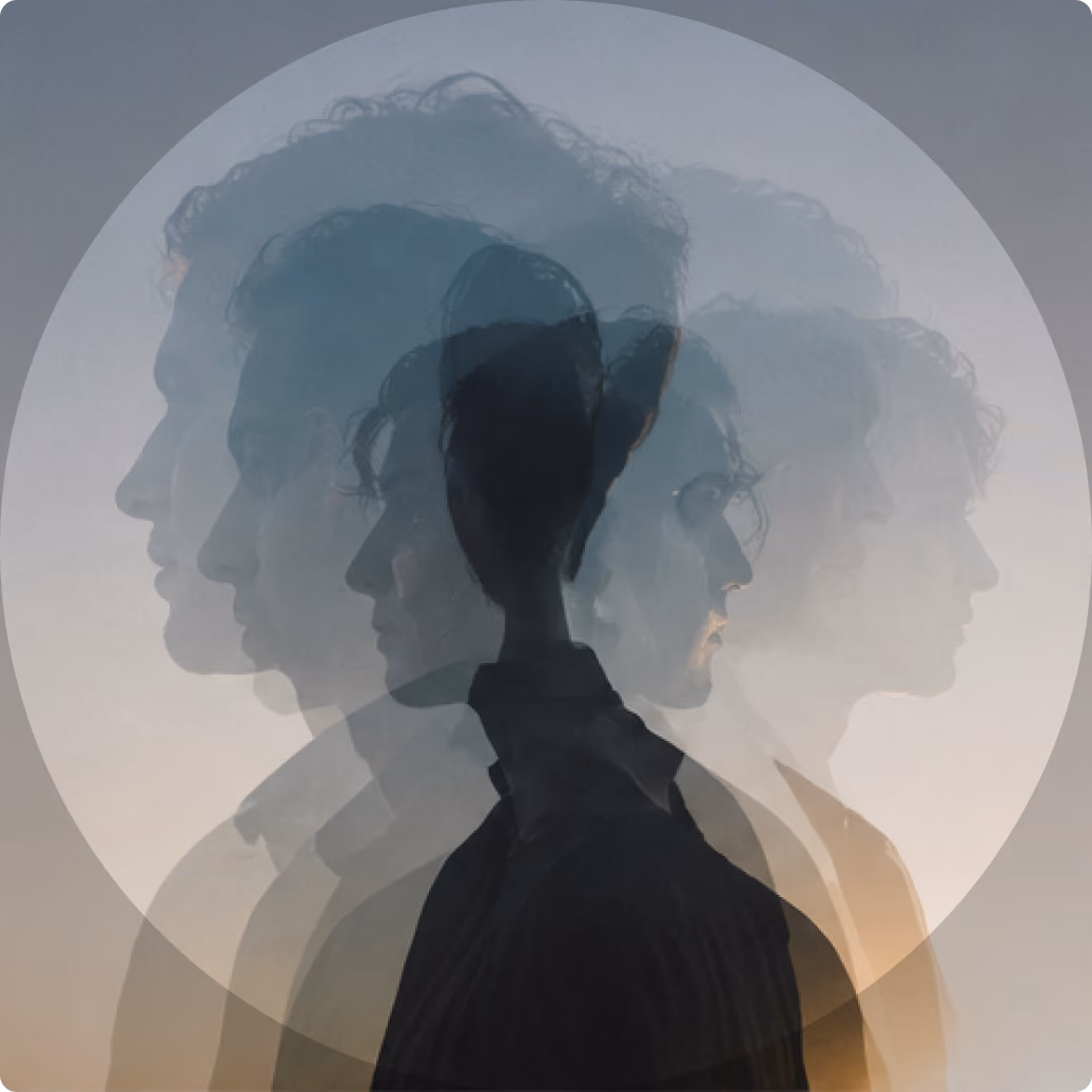 Silhouettes of multiple profiles of a person with curly hair overlapping inside a circular frame, creating a layered, ghostly effect on a neutral background.