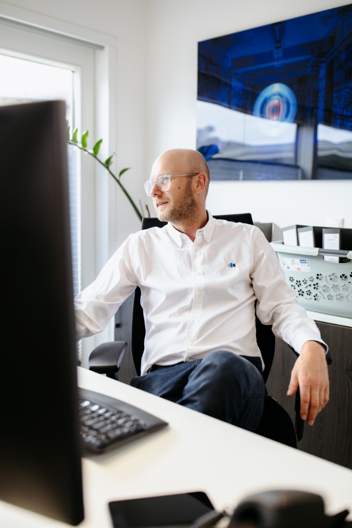 Mitarbeiter im weißen Hemd am Schreibtisch im Büro von A&A Planung