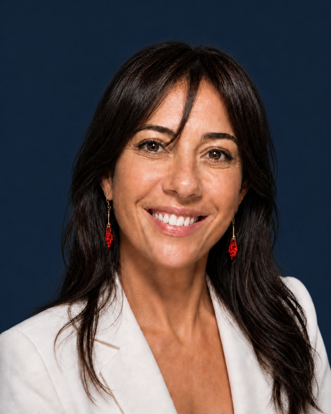 Martina Ursini in a professionale profile pose with blue background and white suit jacket