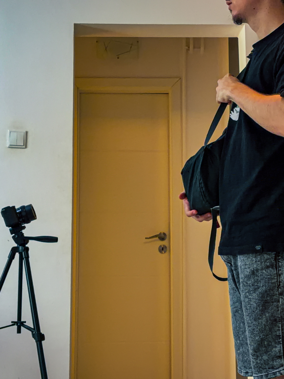 A person standing in the front of camera, filming him.