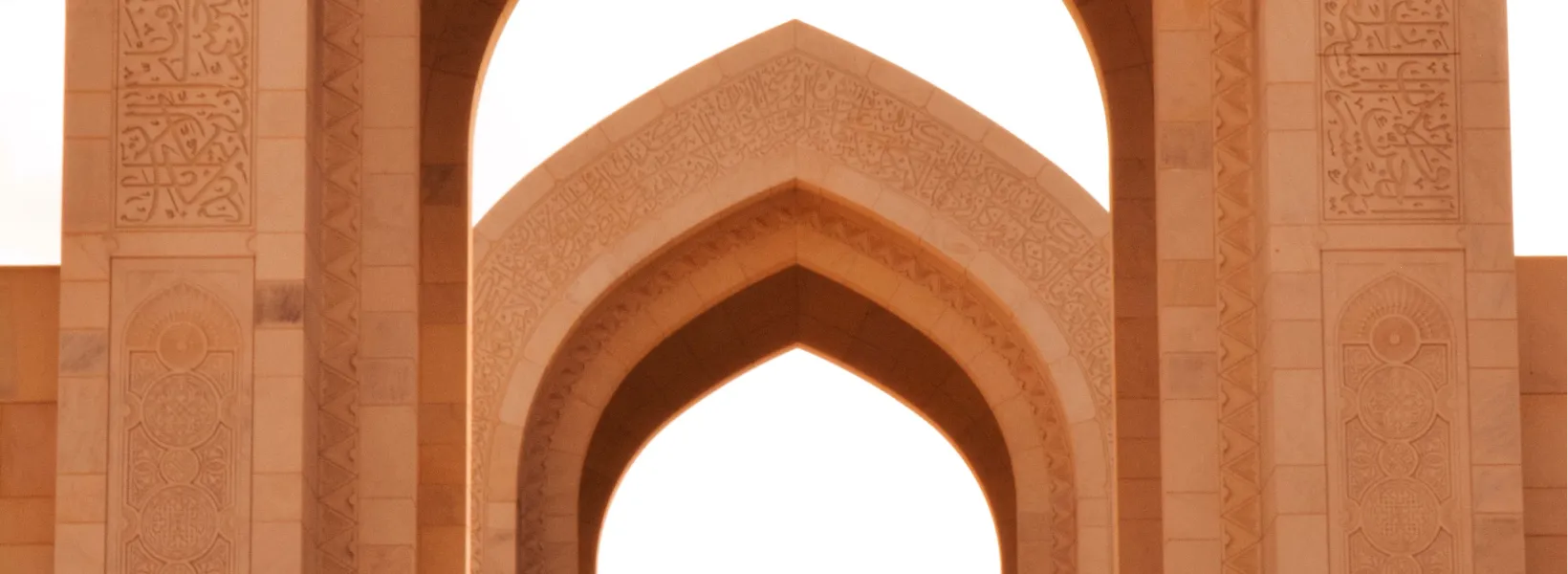 Sunlit succession of stone arches in warm light — layered doorways toward stillness.