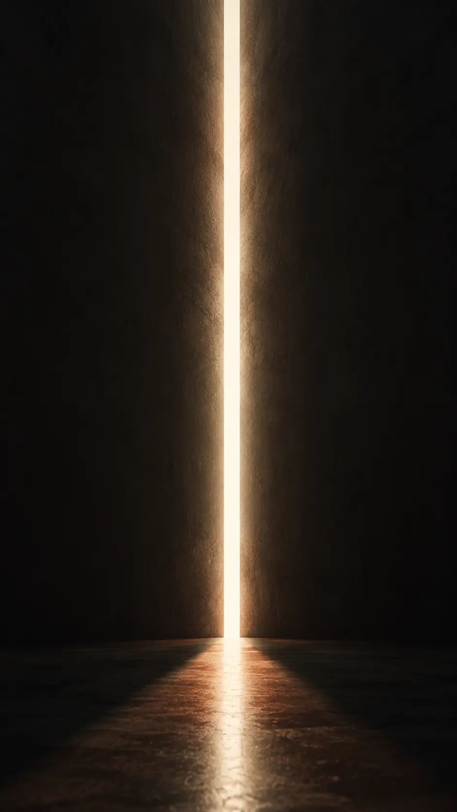 Sottile fessura illuminata da una luce calda che filtra in una stanza buia, riflettendosi sul pavimento.