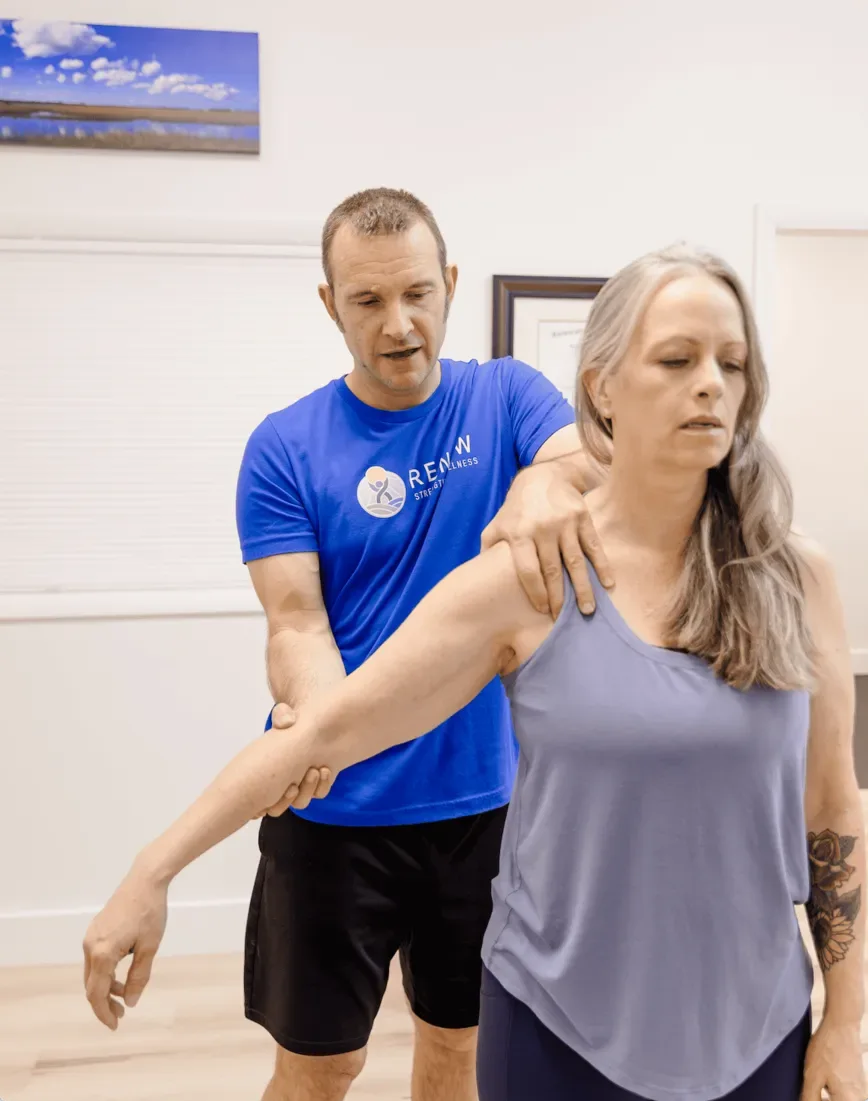 Matt Rieder, DPT, guiding a patient through a shoulder and arm assessment at Renew in St. Augustine, FL