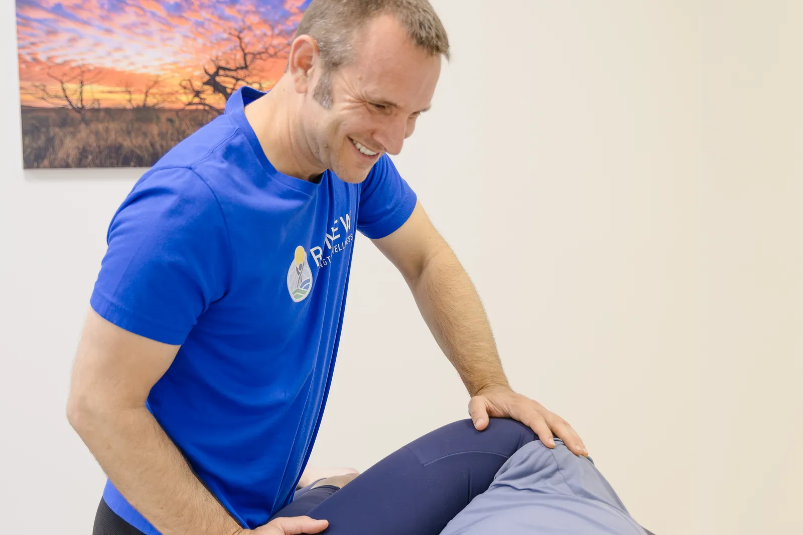 Dr. Matt Rieder, DPT, doing hands-on hip and pelvis treatment at Renew in St. Augustine