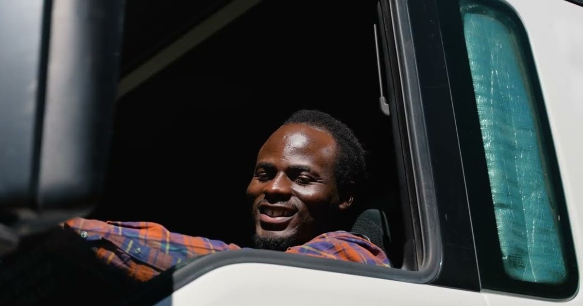 A transporter smiling from his truck cab, from Grand Bay Media's film for BSMART Solutions
