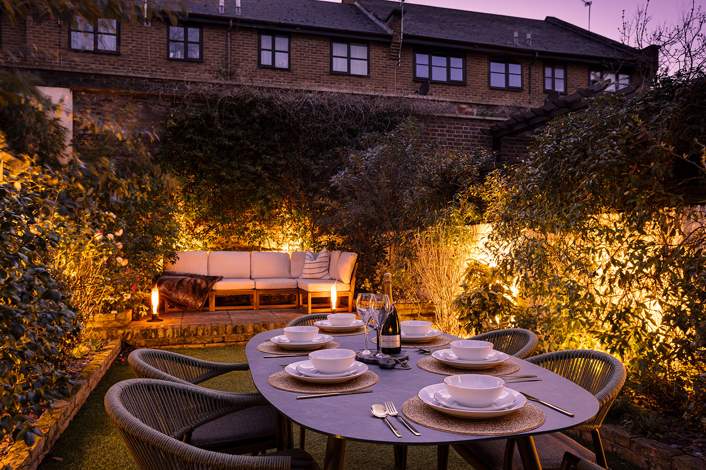 A fully fenced private garden with outdoor furniture, a dining area and a BBQ grill, made for long summer evenings.
