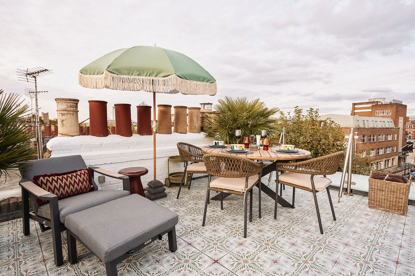 A beautiful roof terrace with outdoor furniture and a dining area, perfect for sunny mornings and evening drinks.