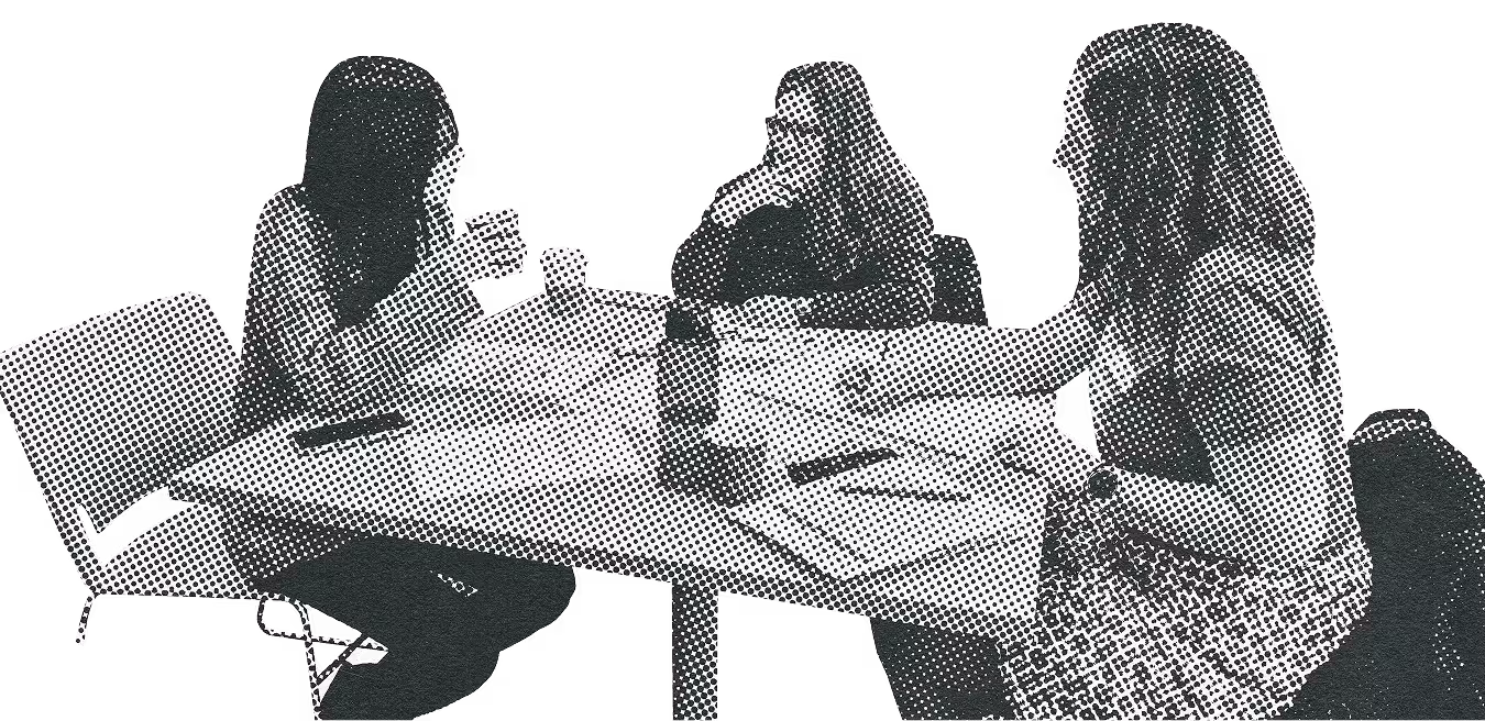 Three individuals in conversation at a table at a Connect the Dots engagement