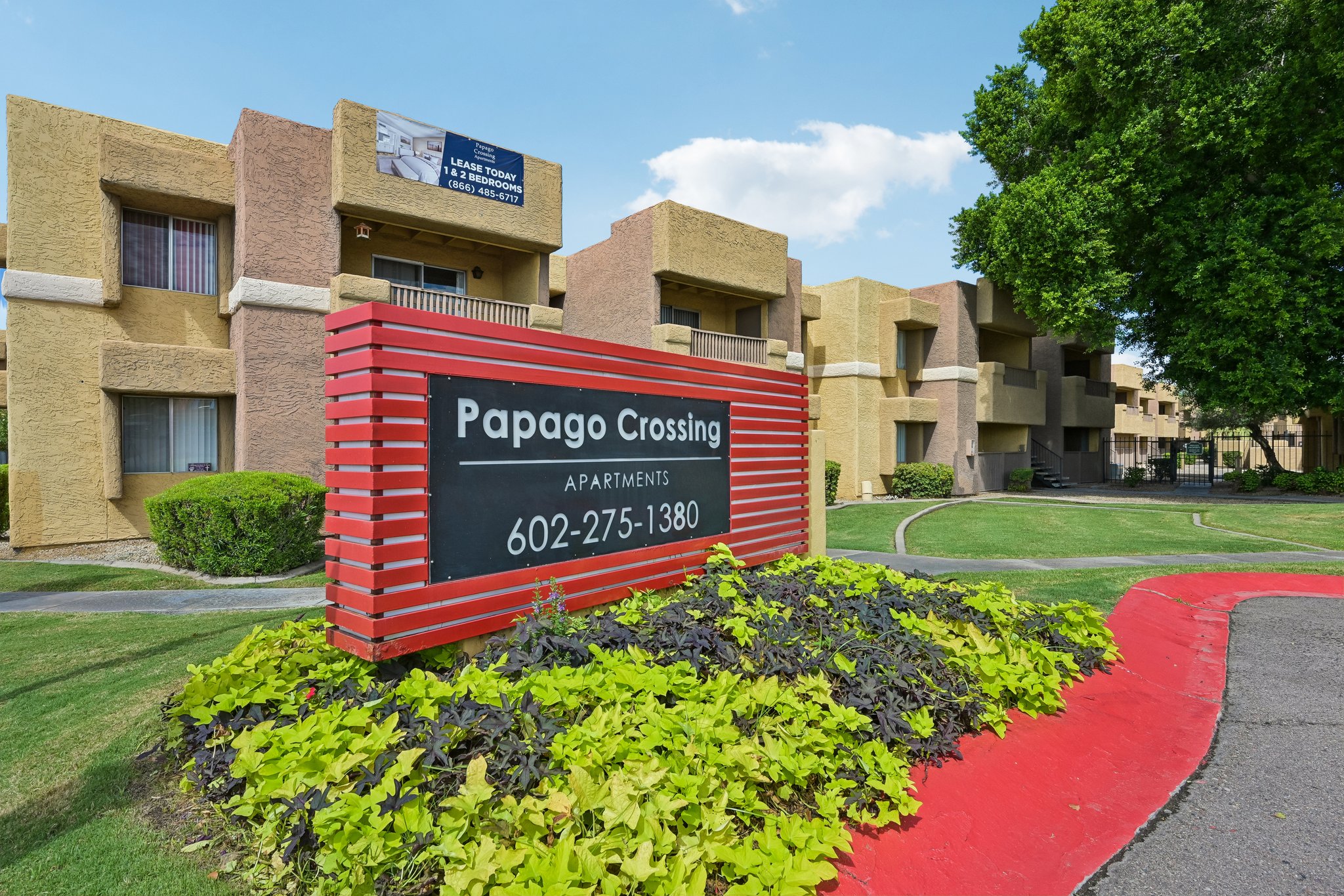 Exterior apartment buildings and landscaped courtyard at Papago Crossing in Phoenix, Arizona