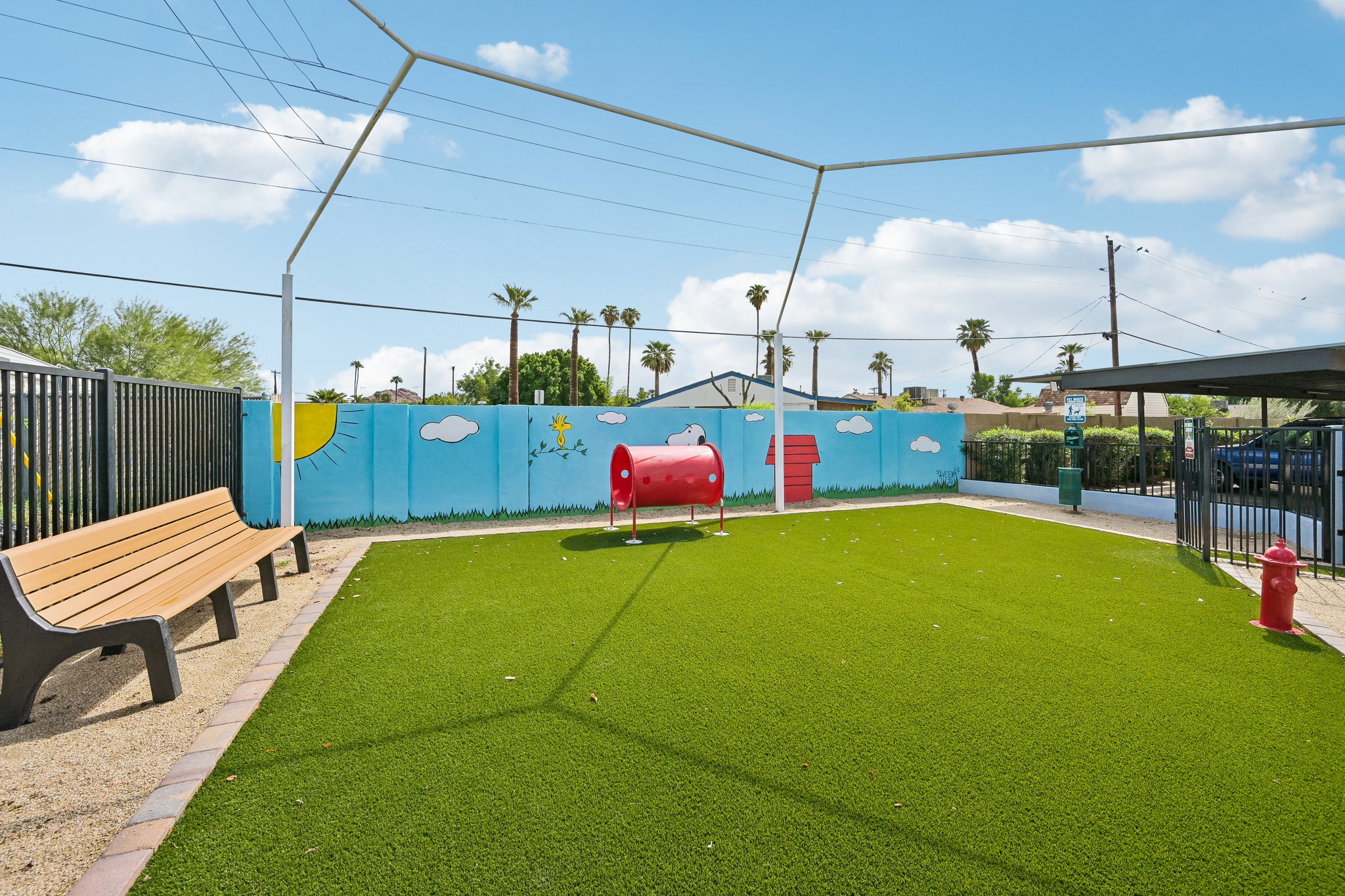 Dog park with green turf seating area at Papago Crossing apartments in Phoenix, Arizona
