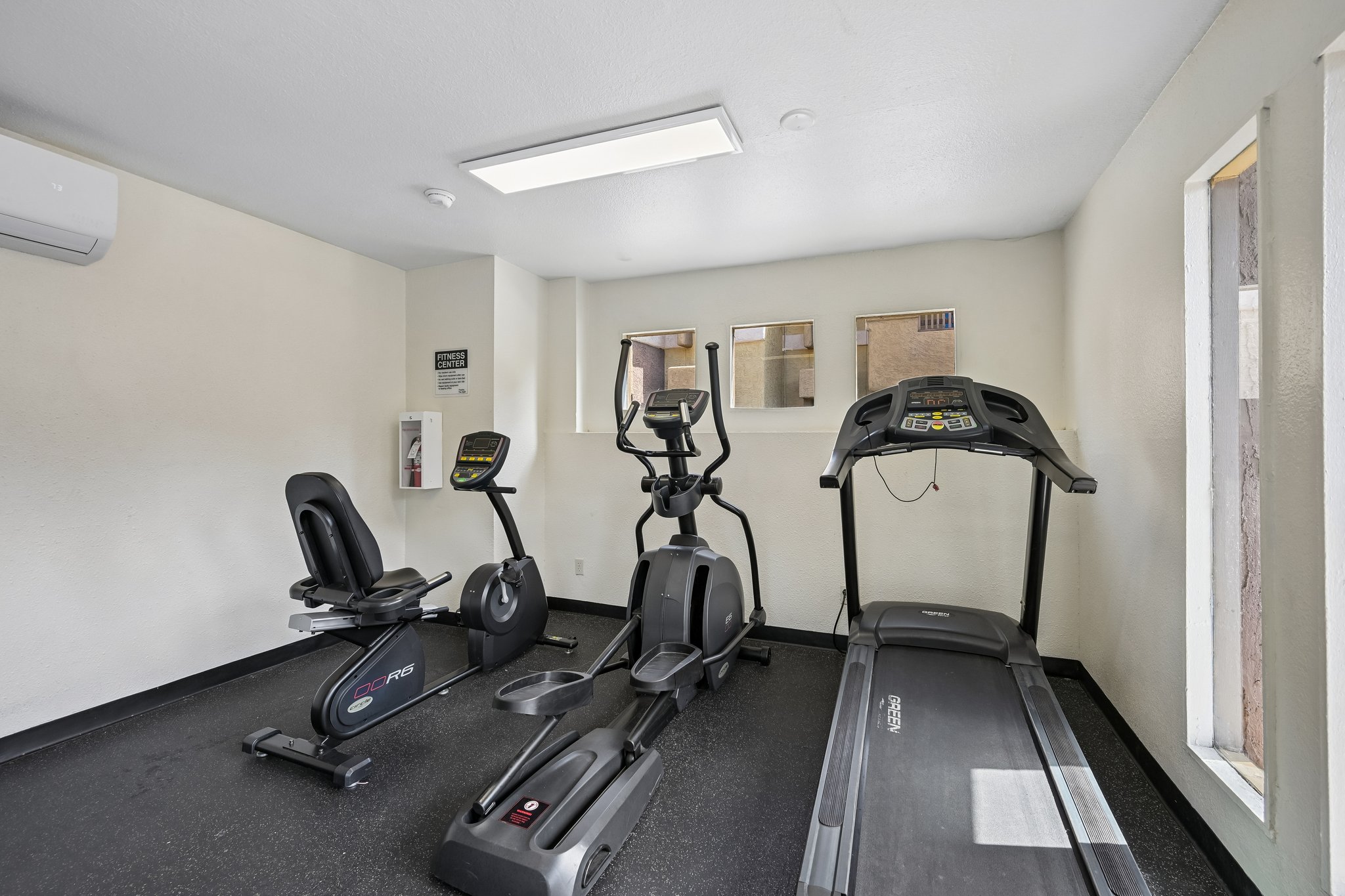 fitness center with elliptical, treadmill and bike machine at Papago Crossing apartments in Phoenix, Arizona