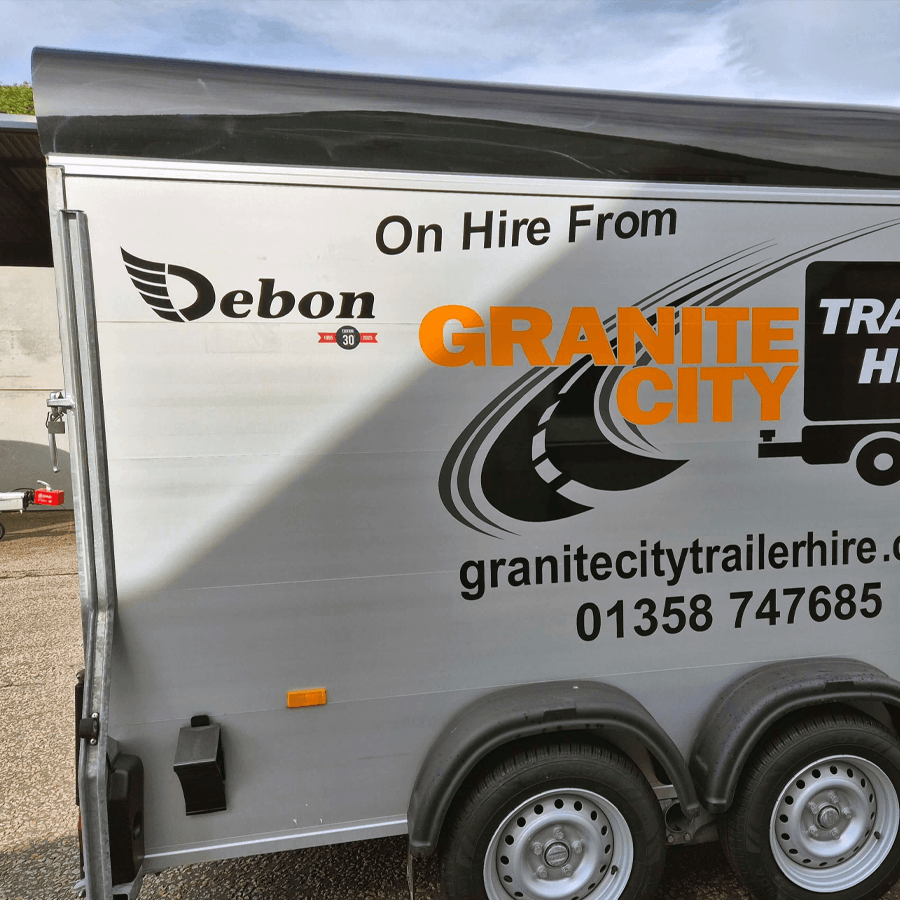 Side of a hire trailer with text 'On Hire From Debon' and 'Granite City' with contact info.