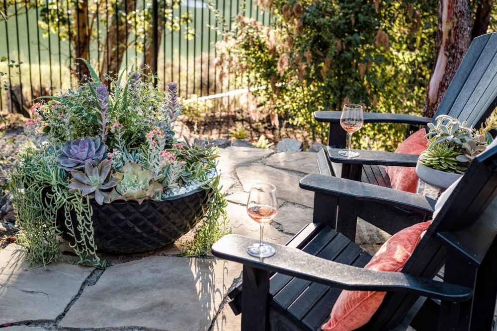 Patio seating area with planters and outdoor lounge chairs