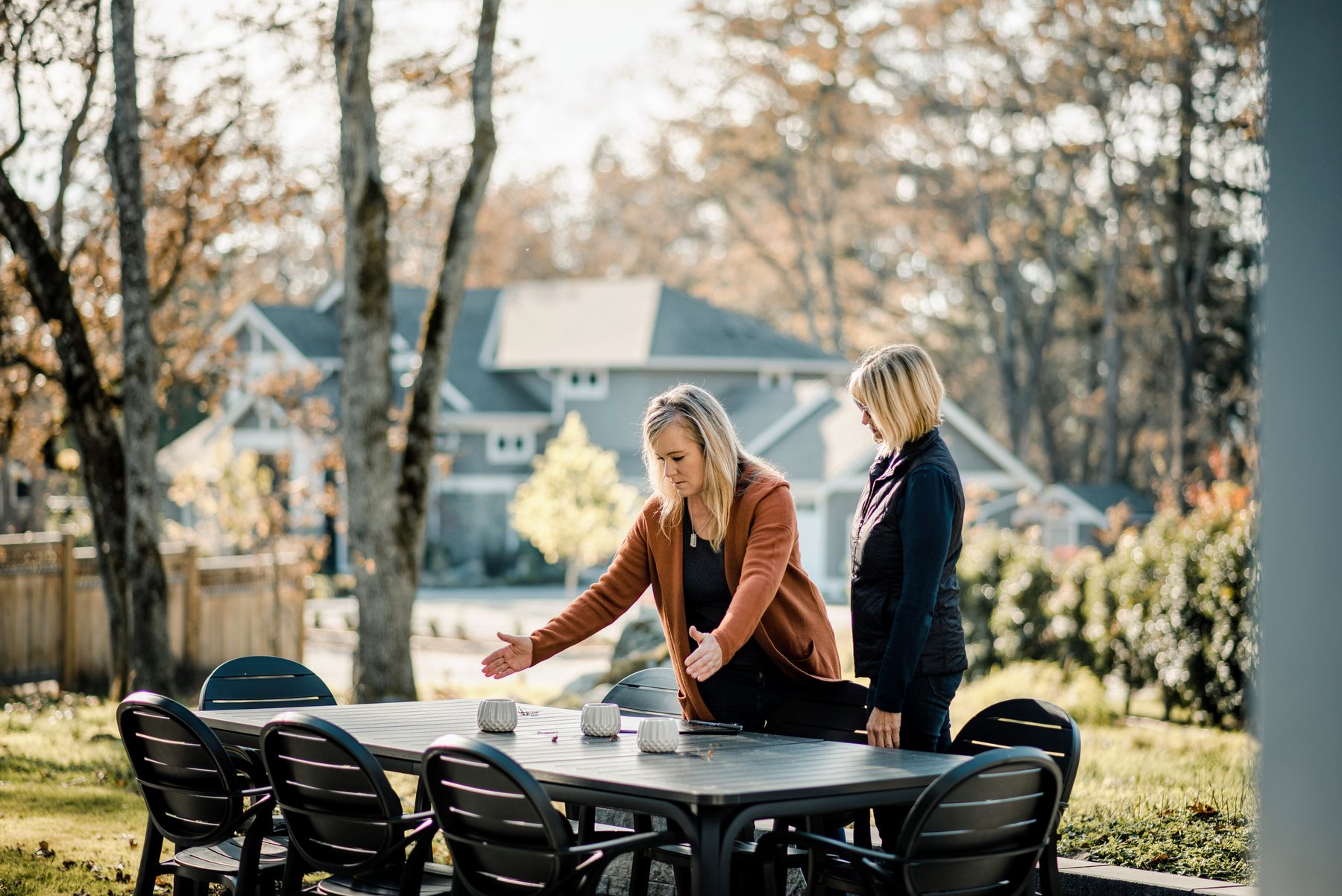 A ModPots designer walking a homeowner through their backyard patio during a site consultation