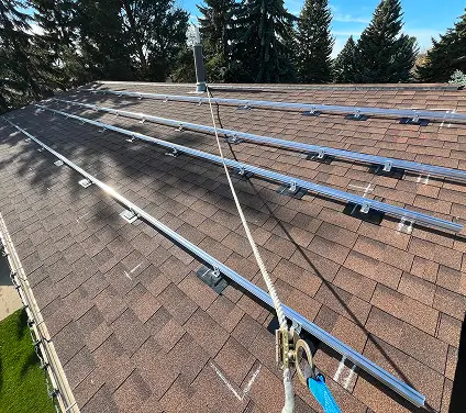 A residential roof featuring multiple solar panels installed for renewable energy generation.