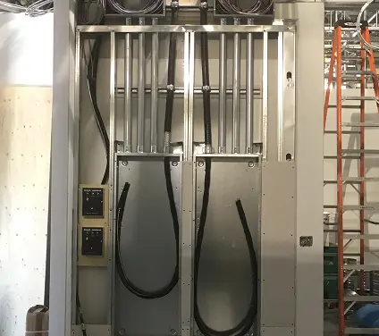 A large metal cabinet housing a prominent electrical panel, showcasing various switches and indicators.