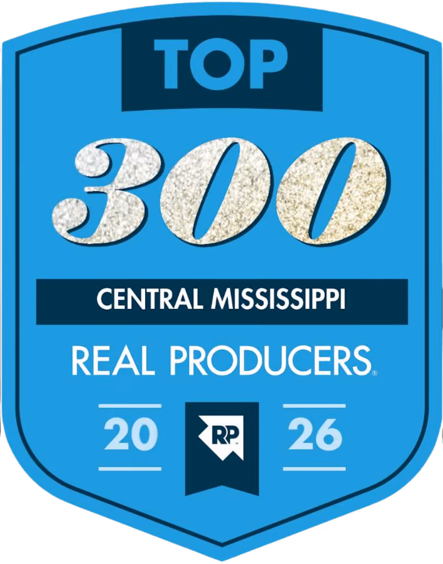 Blue shield-shaped badge with text: 'TOP 300 CENTRAL MISSISSIPPI REAL PRODUCERS 2026' and a small logo with letters RP at the bottom center.
