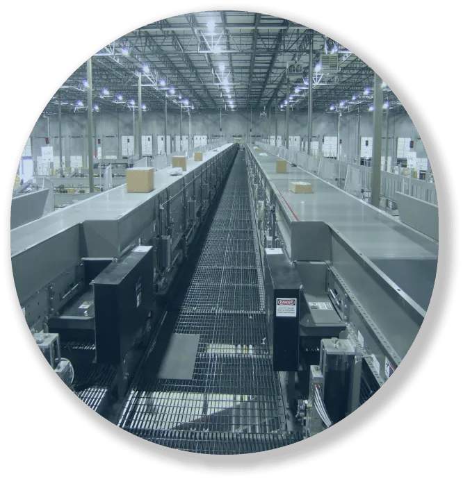 Long warehouse conveyor belts with packages moving, under bright industrial ceiling lights.