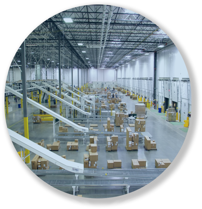 Large warehouse with conveyor belts and stacked boxes arranged for shipping and storage.