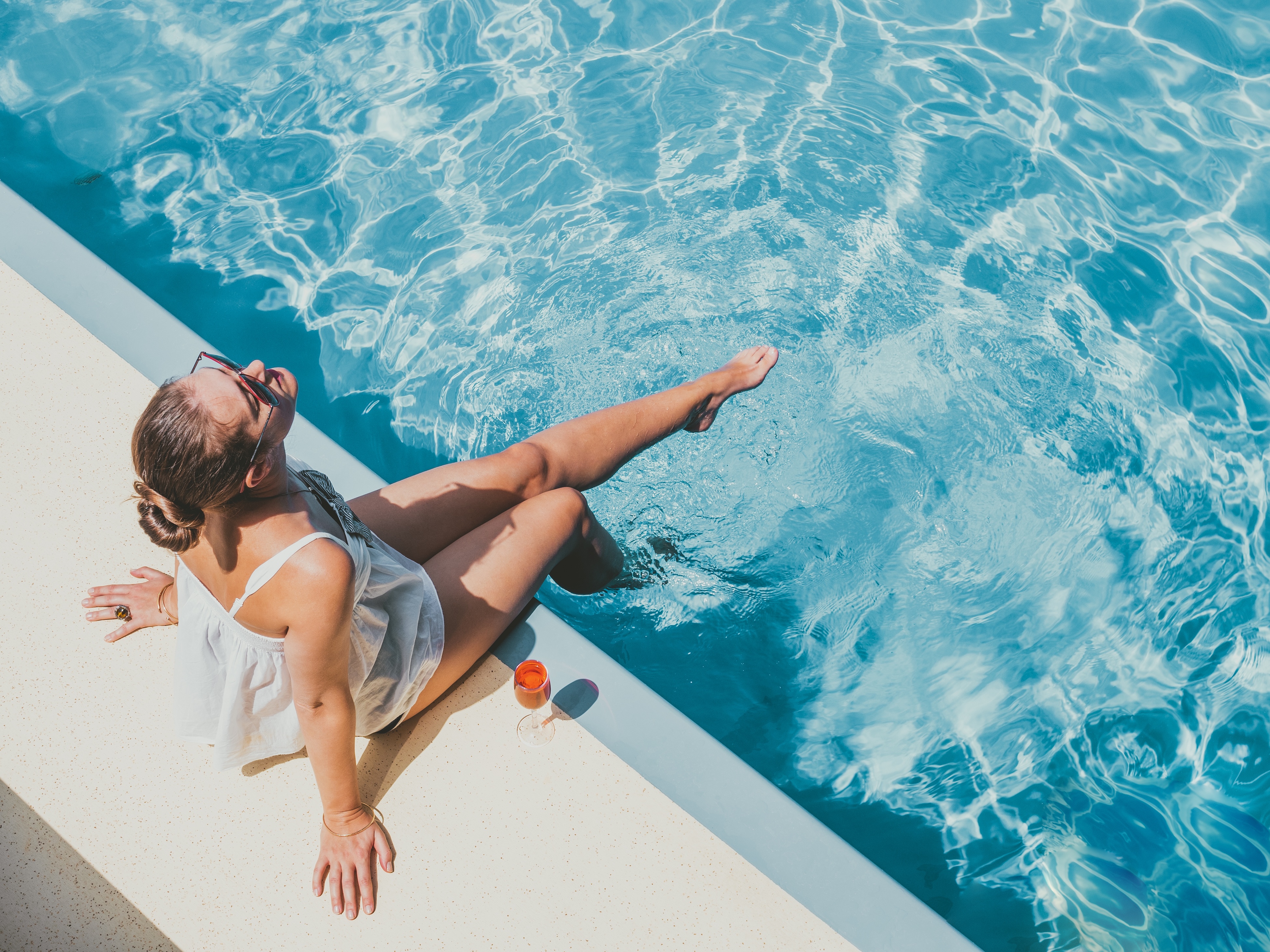 Woman sitting poolside stock image