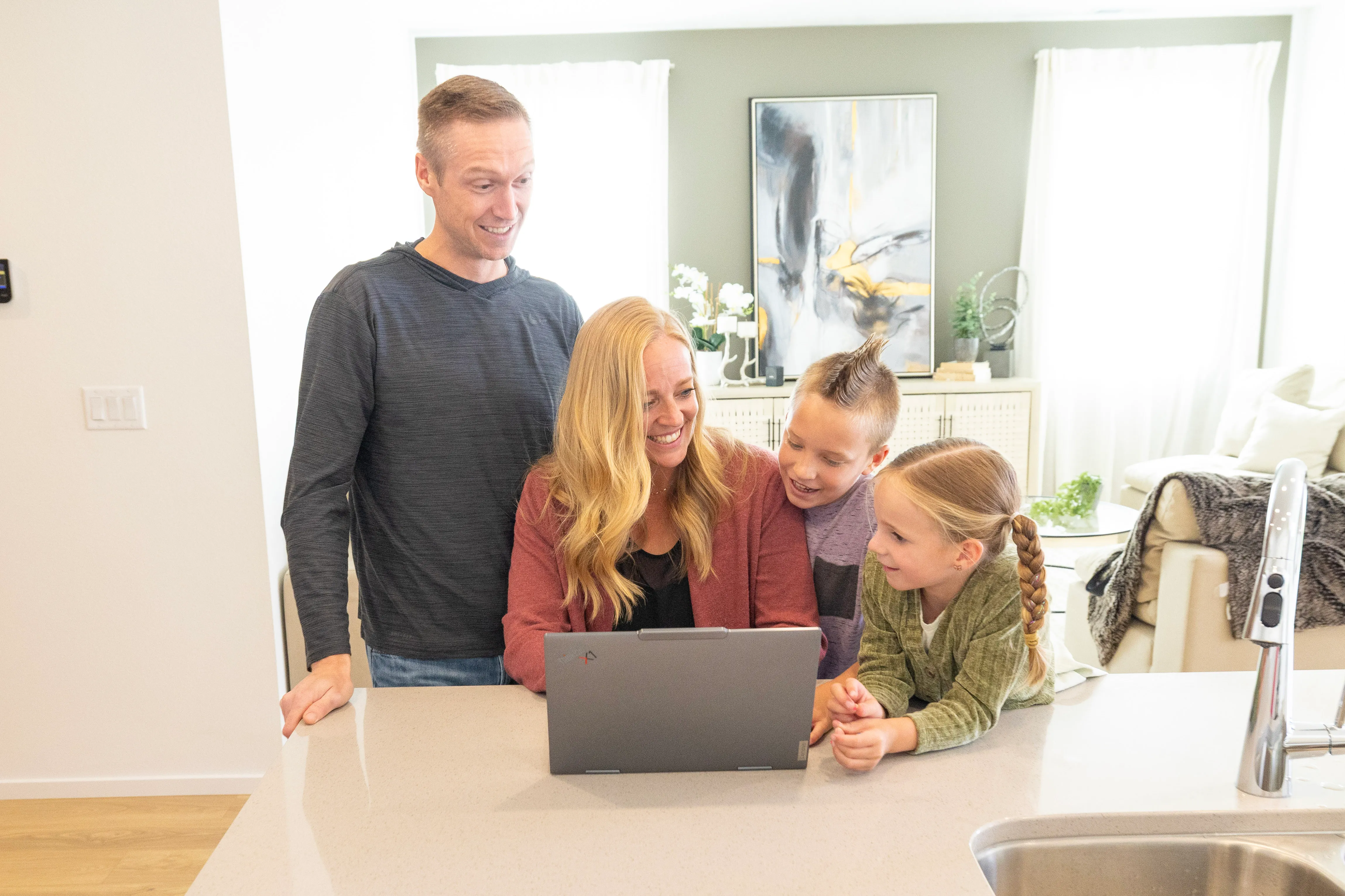 A family being welcomed into a beautifully staged rental home