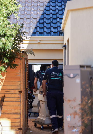 KD Removals crew moving a wrapped sofa