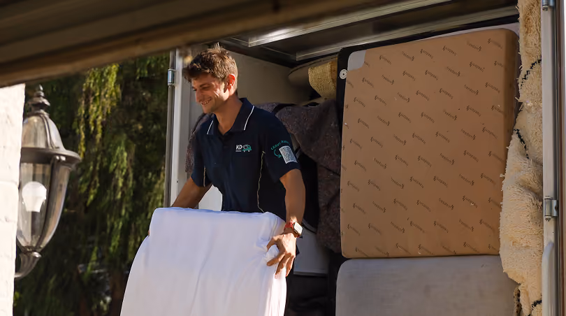 KD removalist carrying boxes to the truck