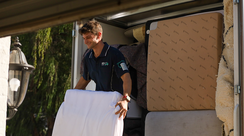 KD removalist carrying boxes to the truck