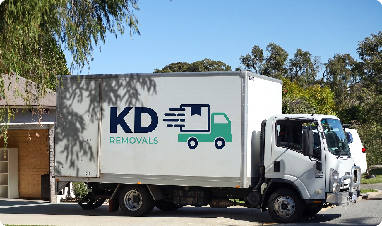 KD Removals team wrapping furniture on moving day
