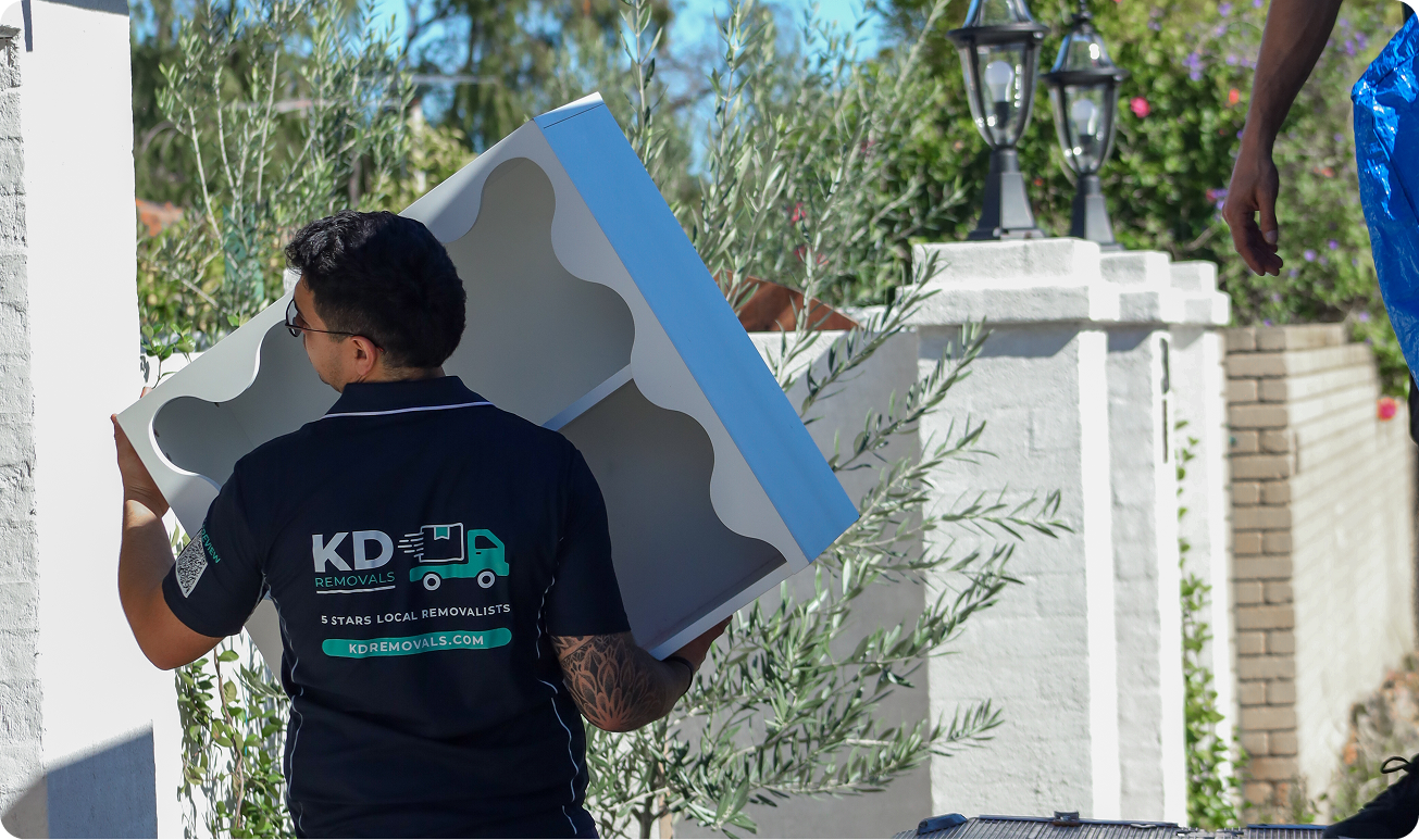 KD Removals crew carrying furniture into a moving truck